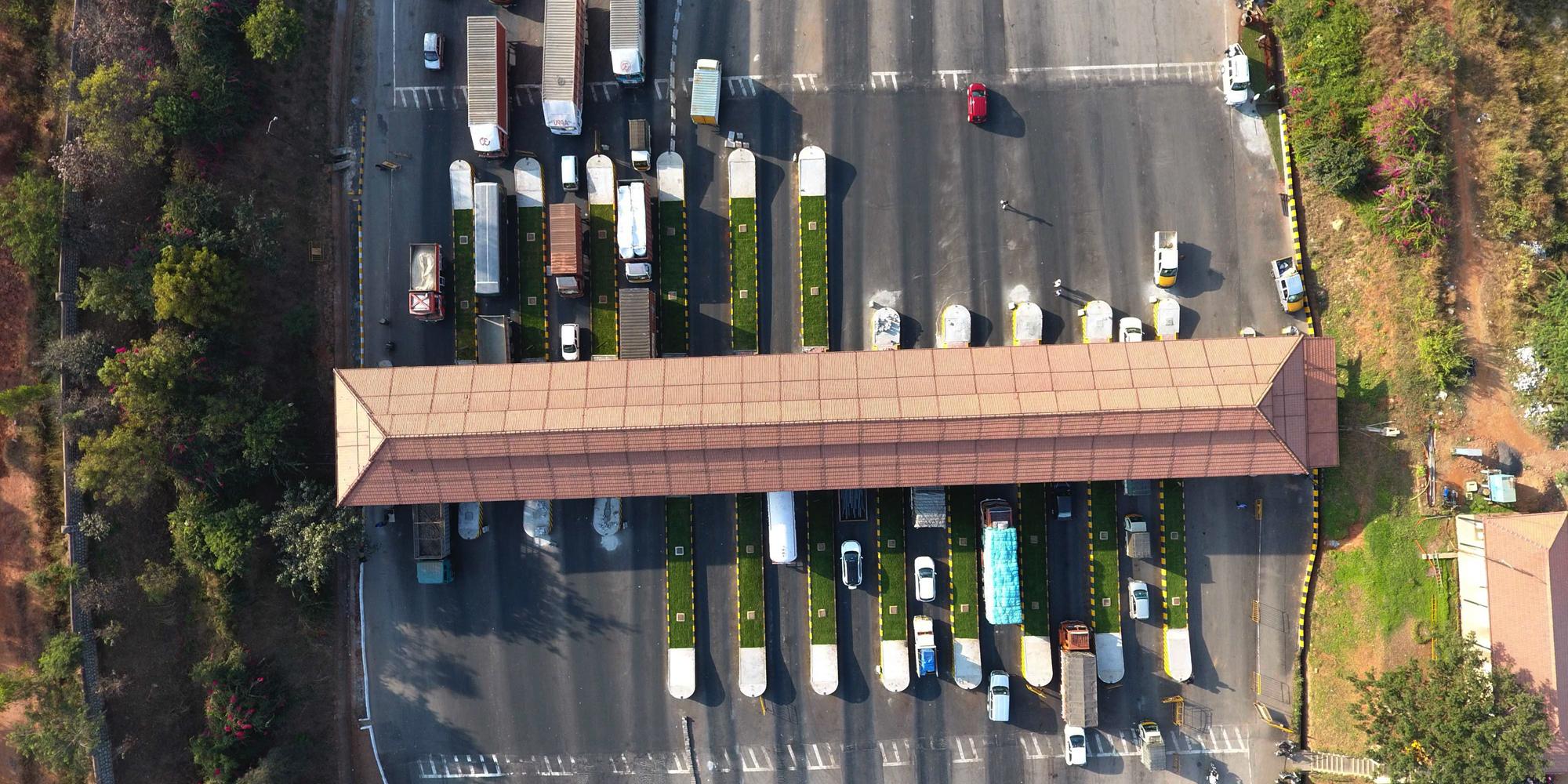 Overhead view of automobiles lined up at a toll booth